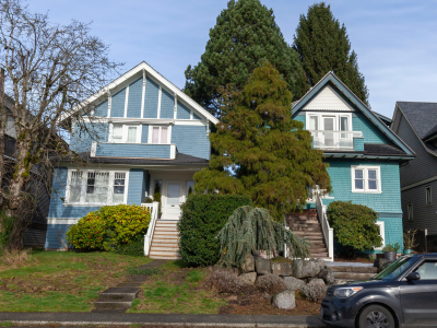 Photo of two heritage houses, one blue and one green