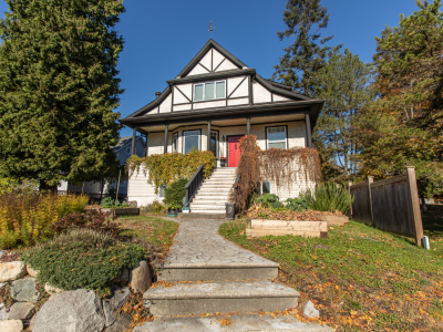 One heritage house with a peaked roof and long stairway
