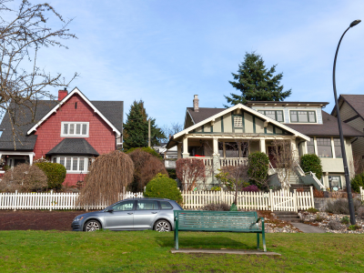 Two heritage houses, one red and one grey
